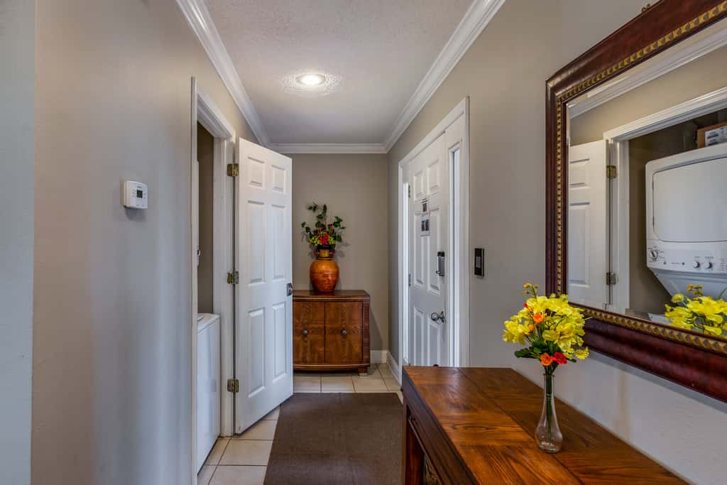 Condo with private balcony, pool, grills, central AC, & WD