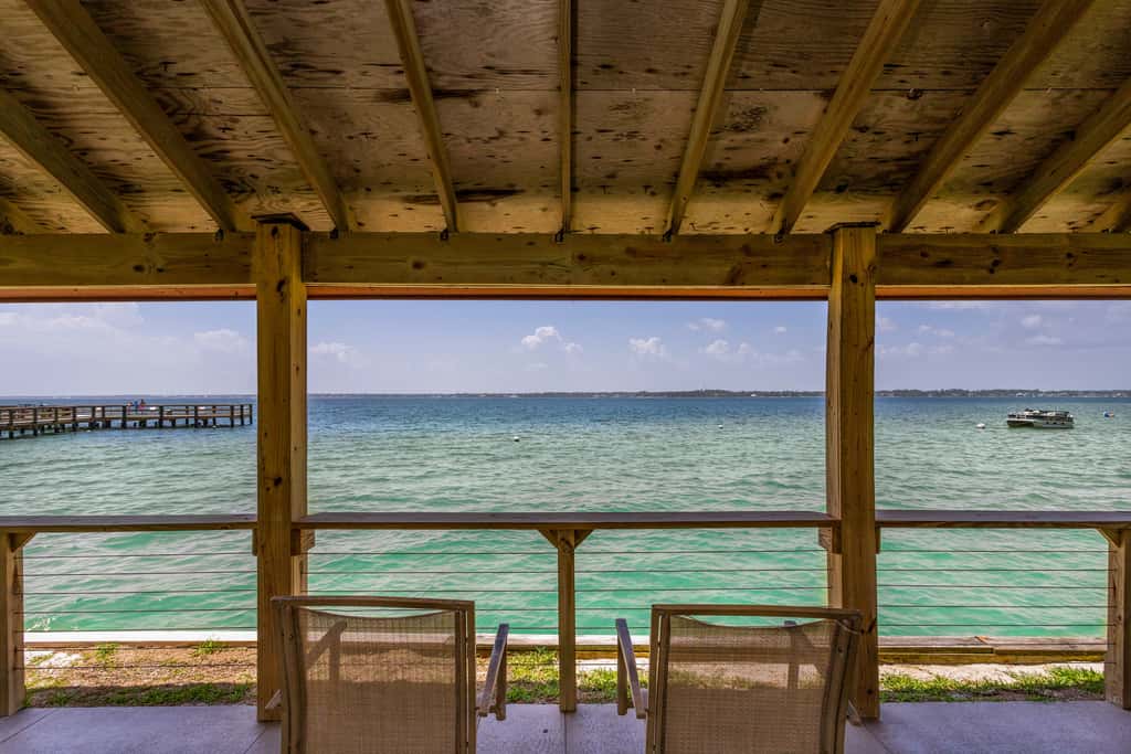 Condo with private balcony, pool, grills, central AC, & WD