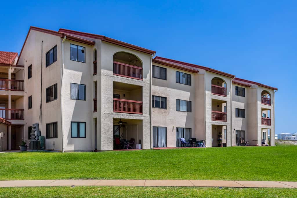 Condo with private balcony, pool, grills, central AC, & WD