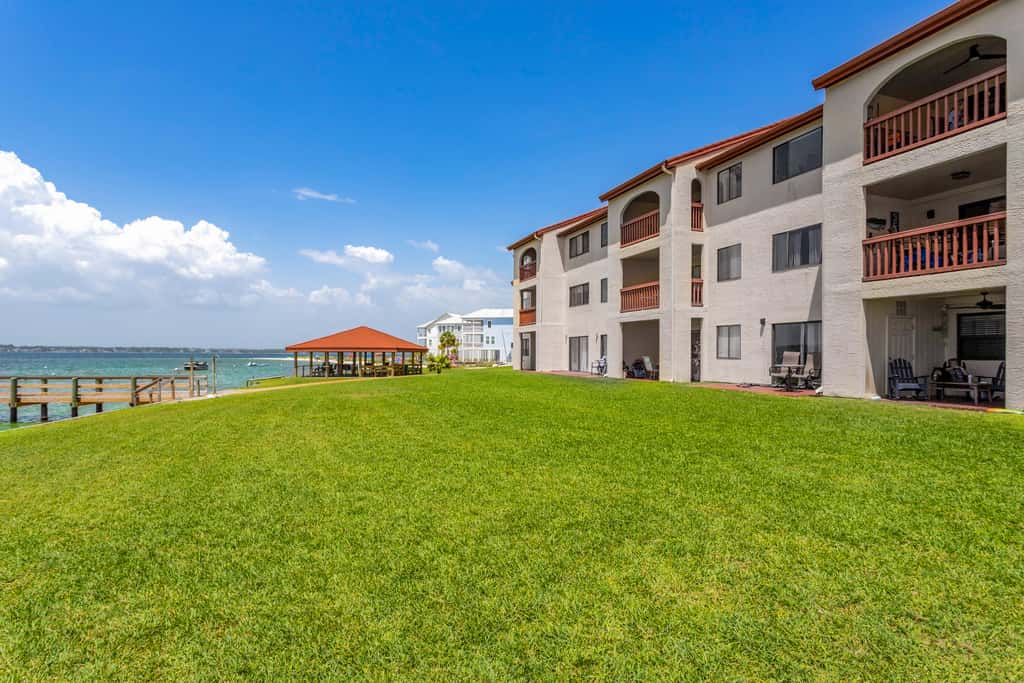 Condo with private balcony, pool, grills, central AC, & WD