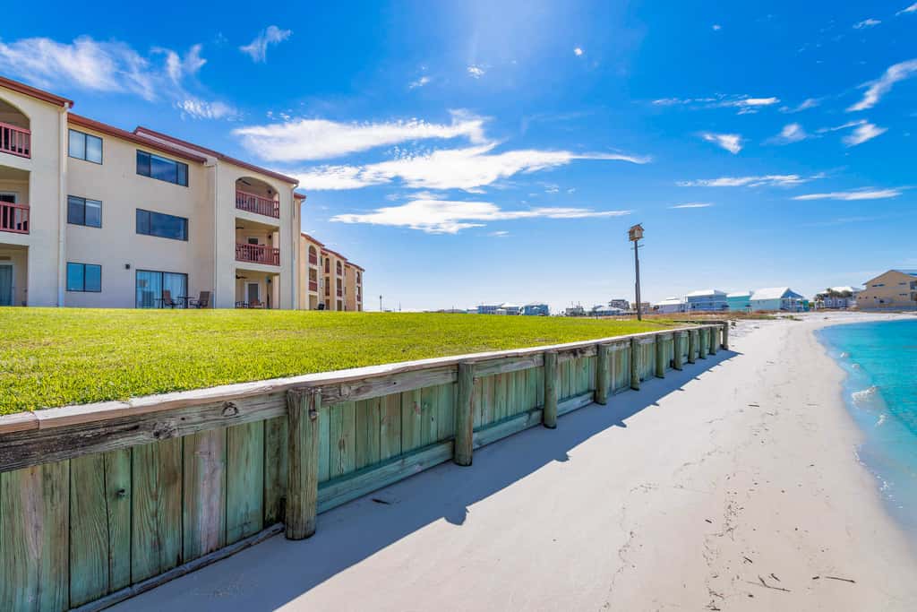 Condo with private balcony, pool, grills, central AC, & WD