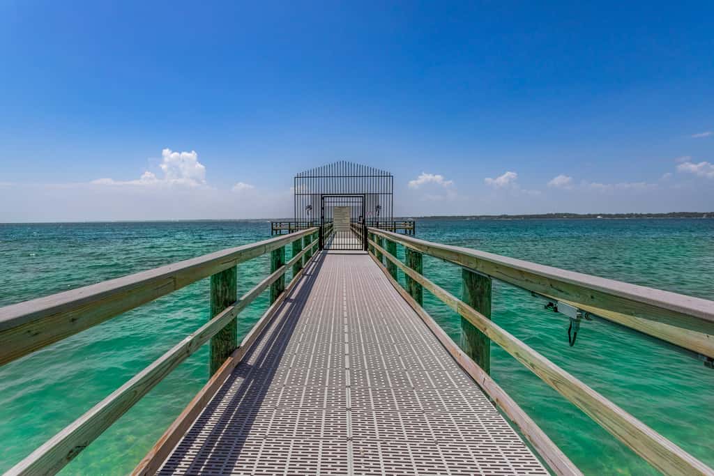 Condo with private balcony, pool, grills, central AC, & WD