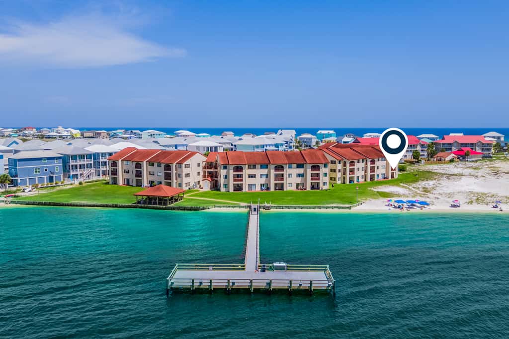 Condo with private balcony, pool, grills, central AC, & WD