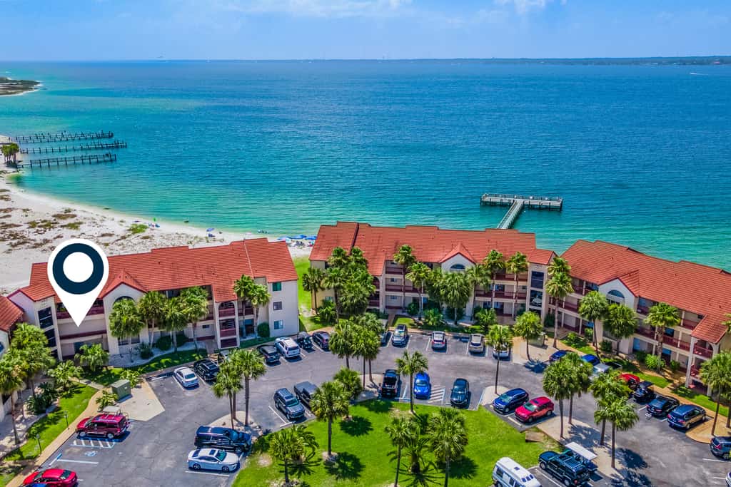 Condo with private balcony, pool, grills, central AC, & WD