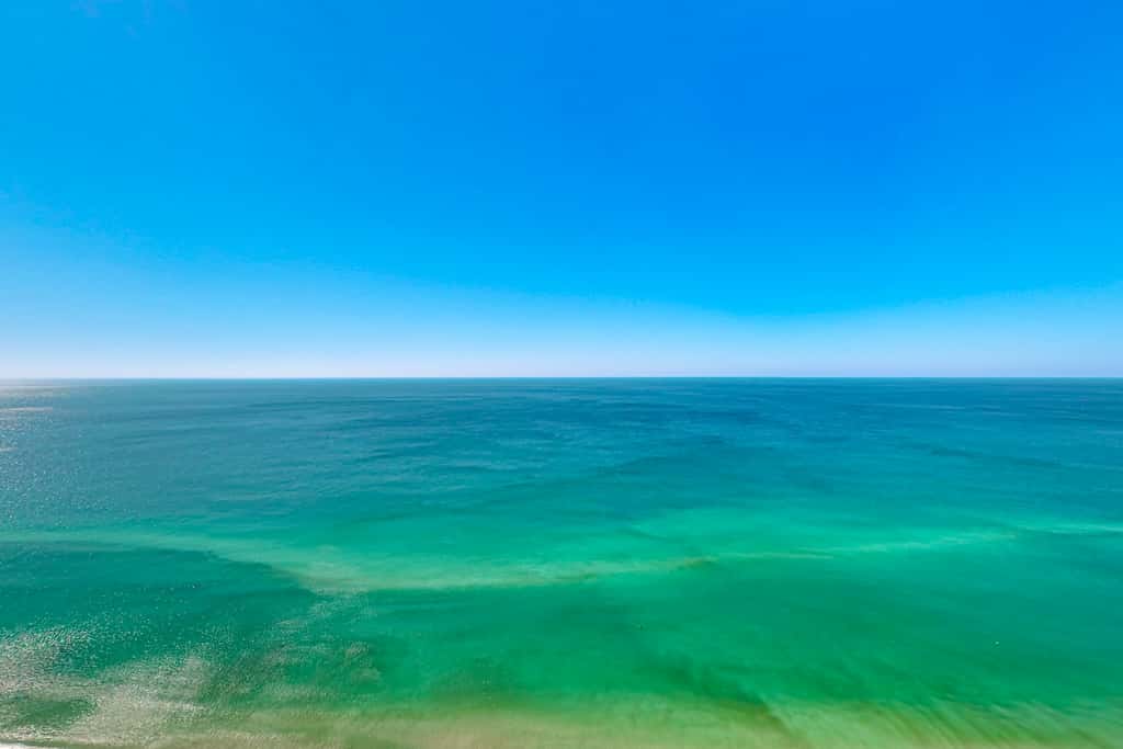 Escape to this waterfront condo with shared pools, a gym, & easy beach access