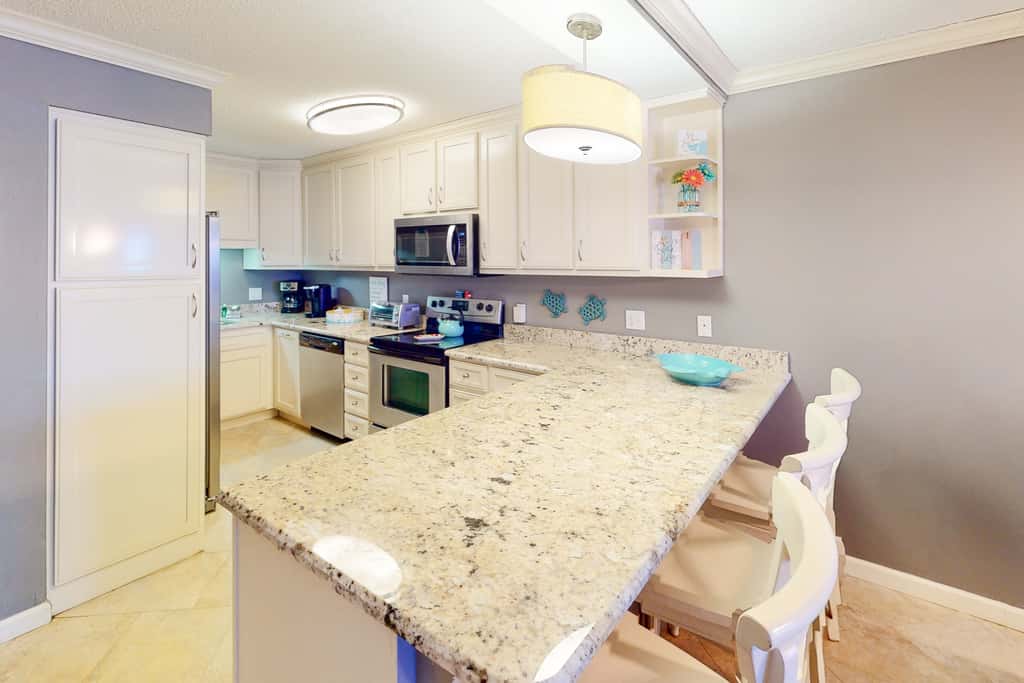 Beachfront condo with ocean-view balcony, pools, hot tub, gym, central AC, & WD