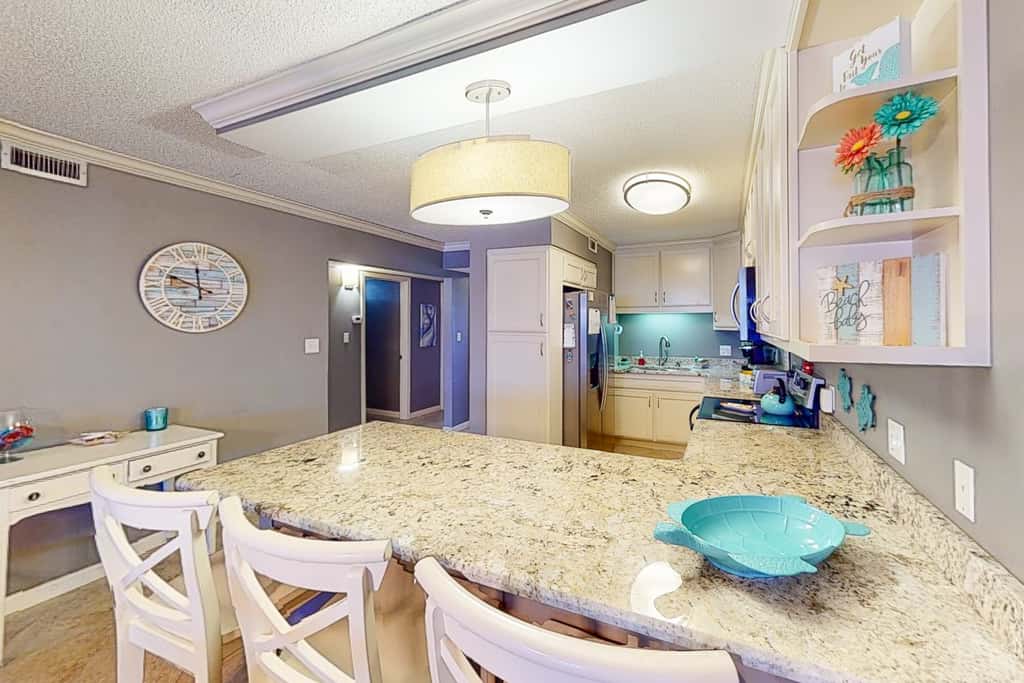 Beachfront condo with ocean-view balcony, pools, hot tub, gym, central AC, & WD