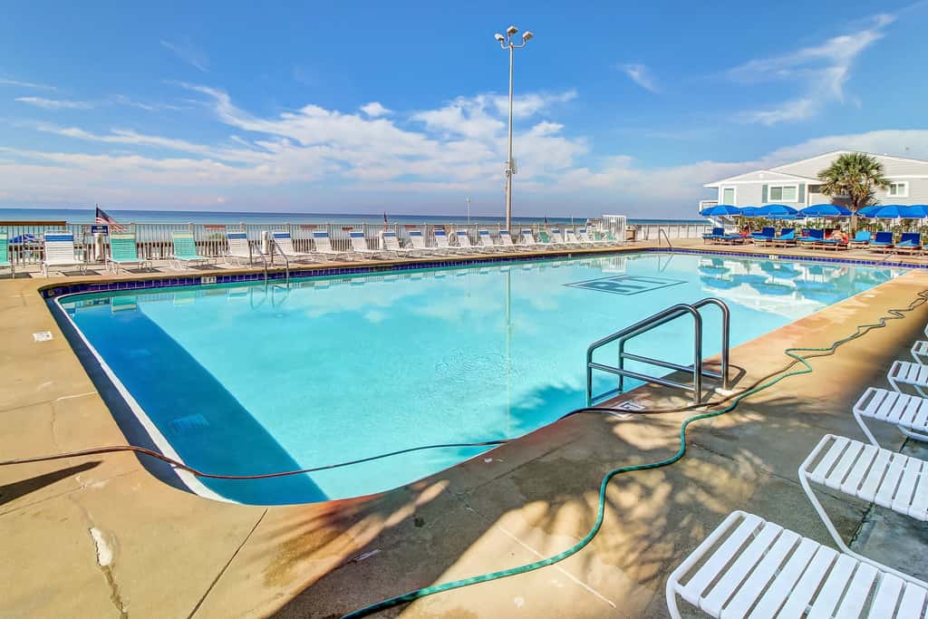 Stunning beachfront condo w/ beach access, shared pool, & private balcony