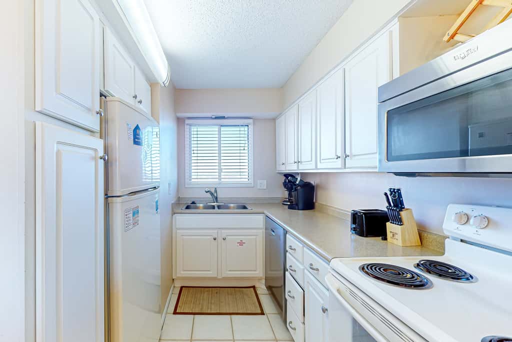 Stunning beachfront condo w/ beach access, shared pool, & private balcony