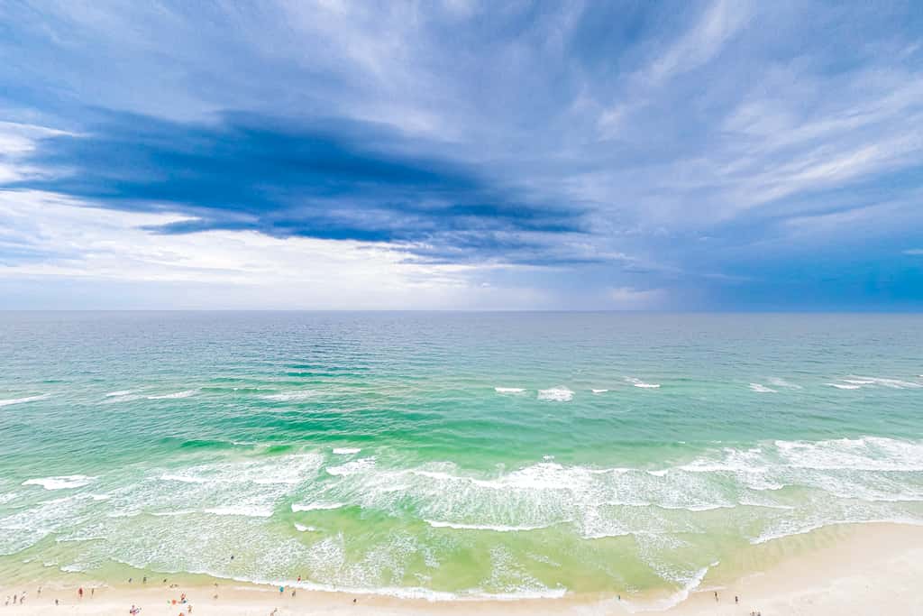Superb beach living at lovely waterfront condo with pools, a gym, & hot tub