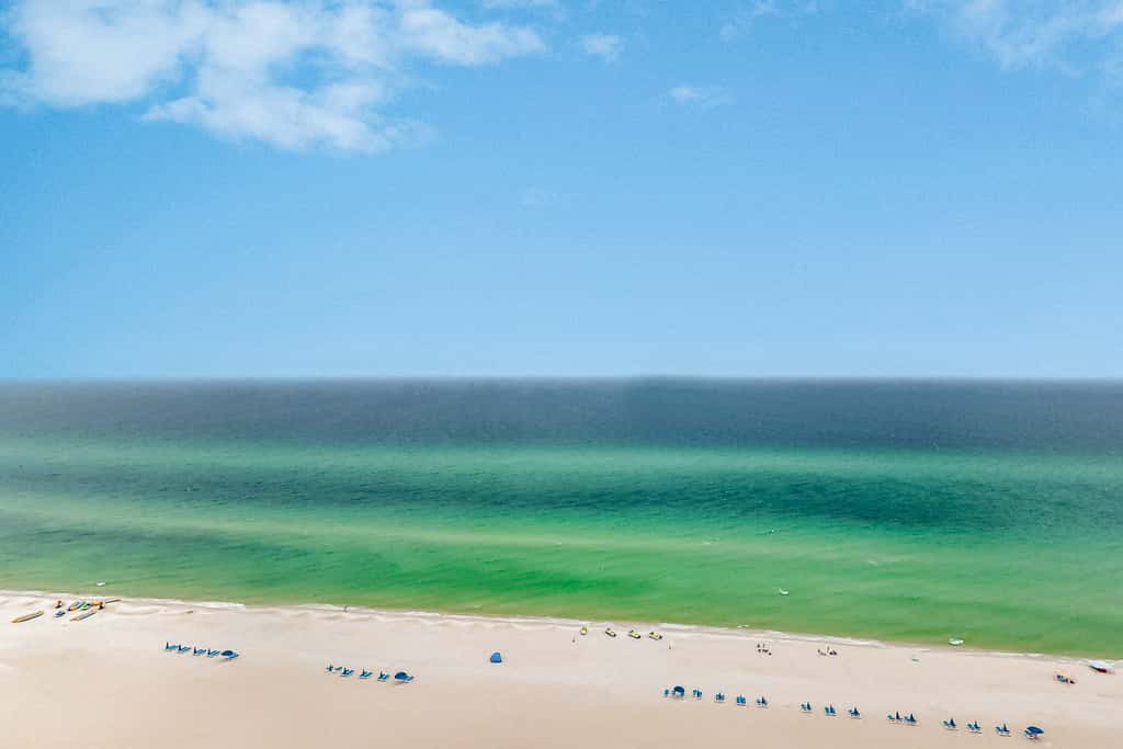 14th-floor oceanfront condo with Gulf views, outdoor pool, balcony, WD, & AC