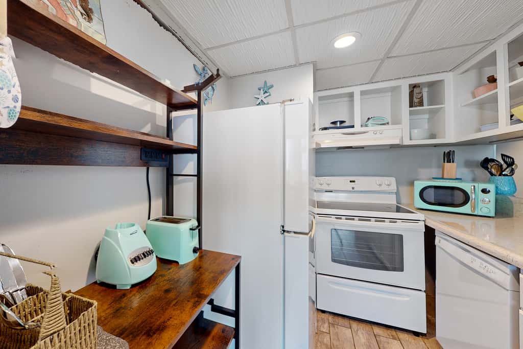 Gulf-view condo with pools, beach access, gym, grills, & updated interior