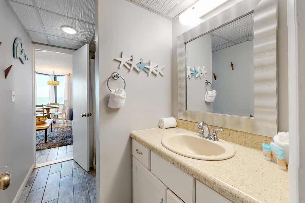 Gulf-view condo with pools, beach access, gym, grills, & updated interior