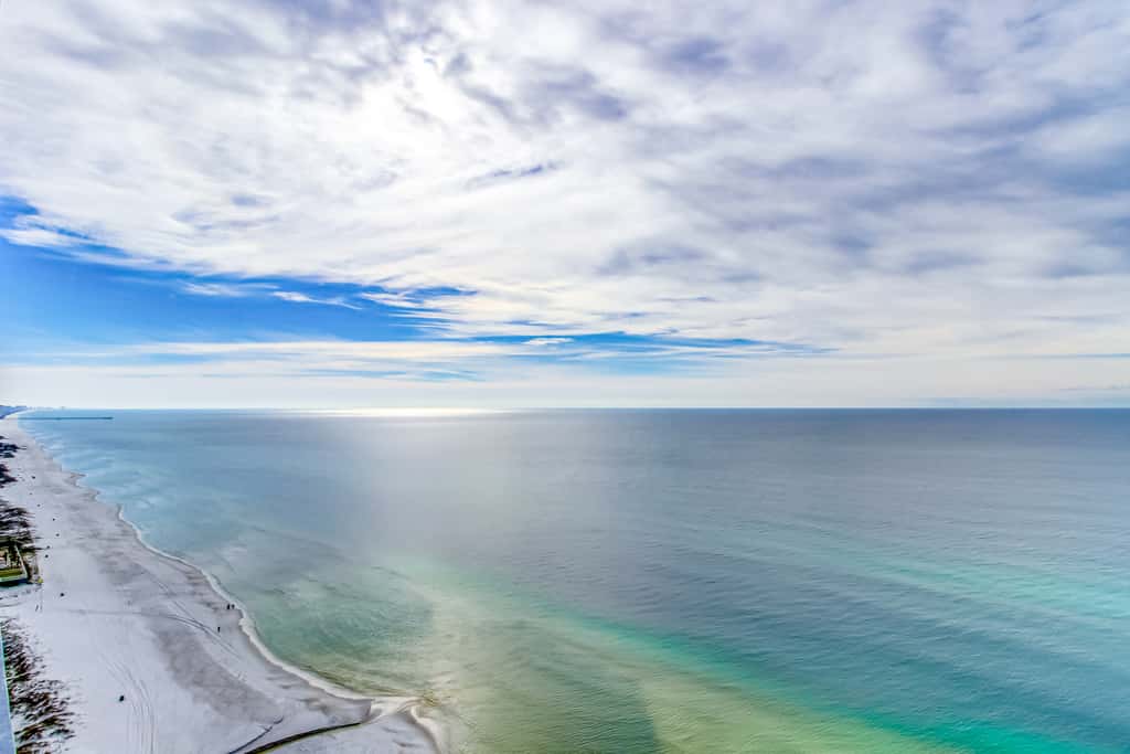 Colorful, beachfront condo with Gulf view, pool, hot tub, and lazy river