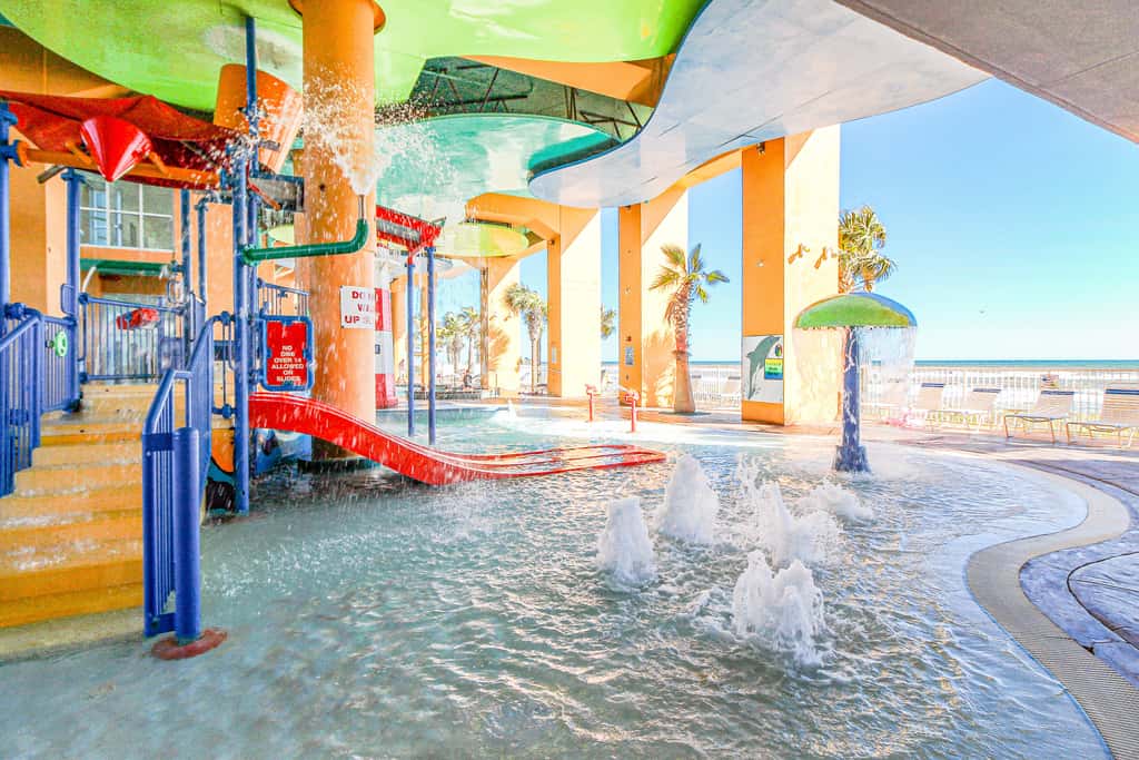 Colorful, beachfront condo with Gulf view, pool, hot tub, and lazy river
