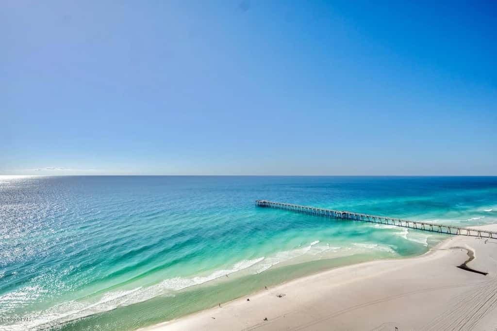 Gulf-front condo with pier views, balcony, heated pool, gym & AC