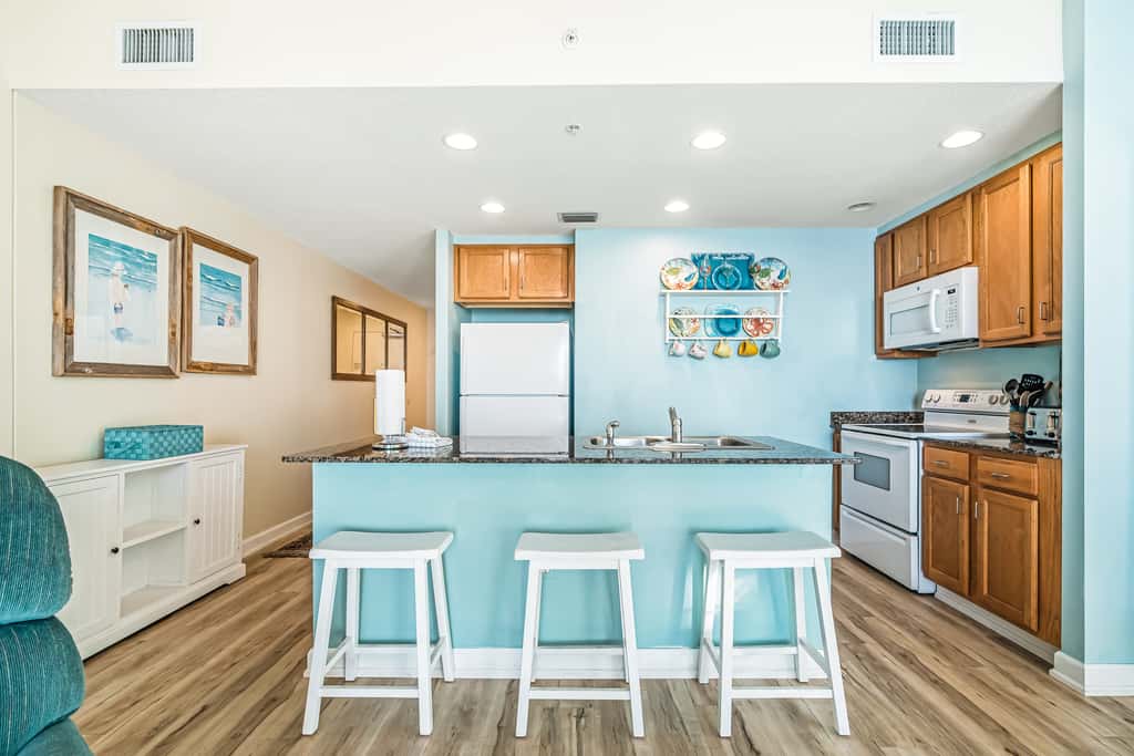 Snow-bird friendly condo with pool & fitness room - walk right out to the sand