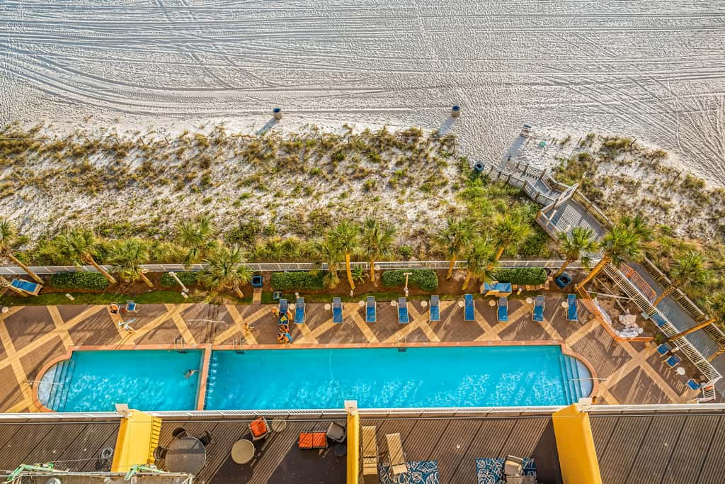 Snow-bird friendly condo with pool & fitness room - walk right out to the sand