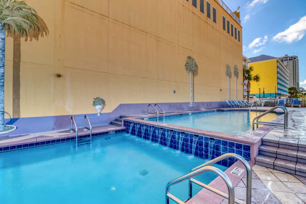 Snow-bird friendly condo with pool & fitness room - walk right out to the sand