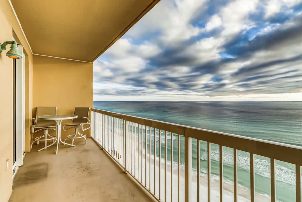 Serene & upscale beachfront condo with furnished balcony, view, & pools