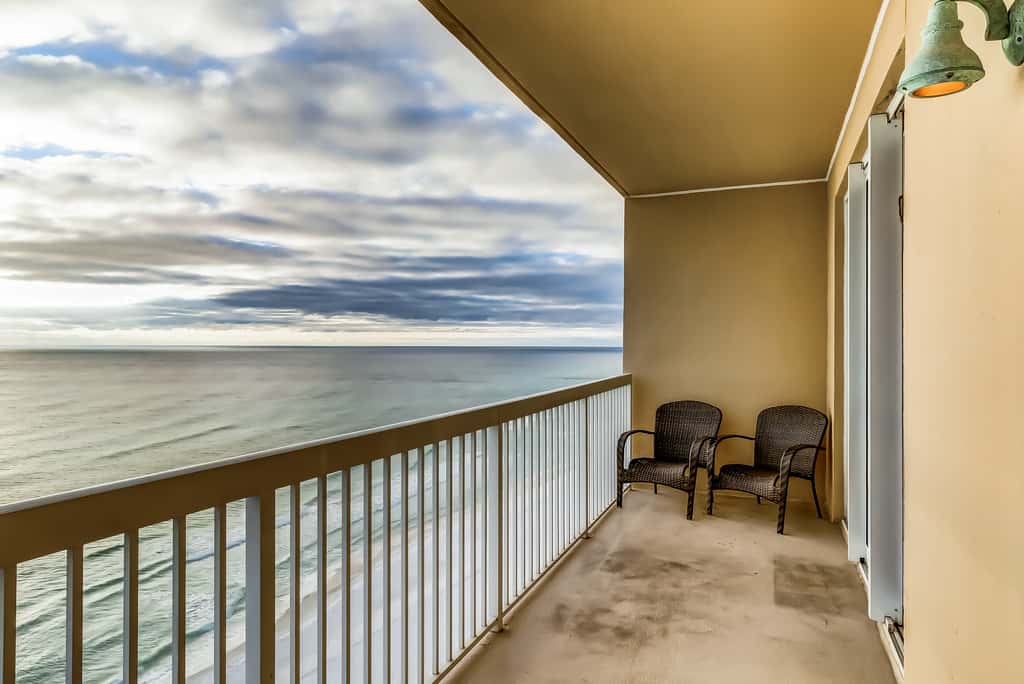 Serene & upscale beachfront condo with furnished balcony, view, & pools