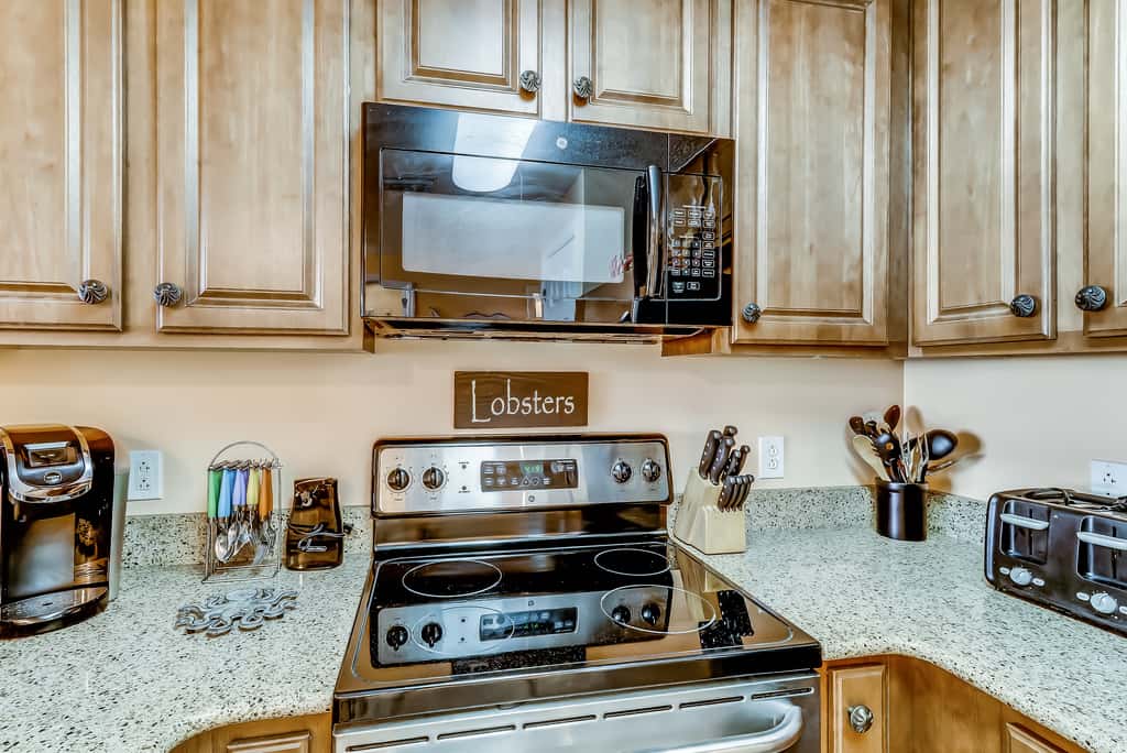Serene & upscale beachfront condo with furnished balcony, view, & pools