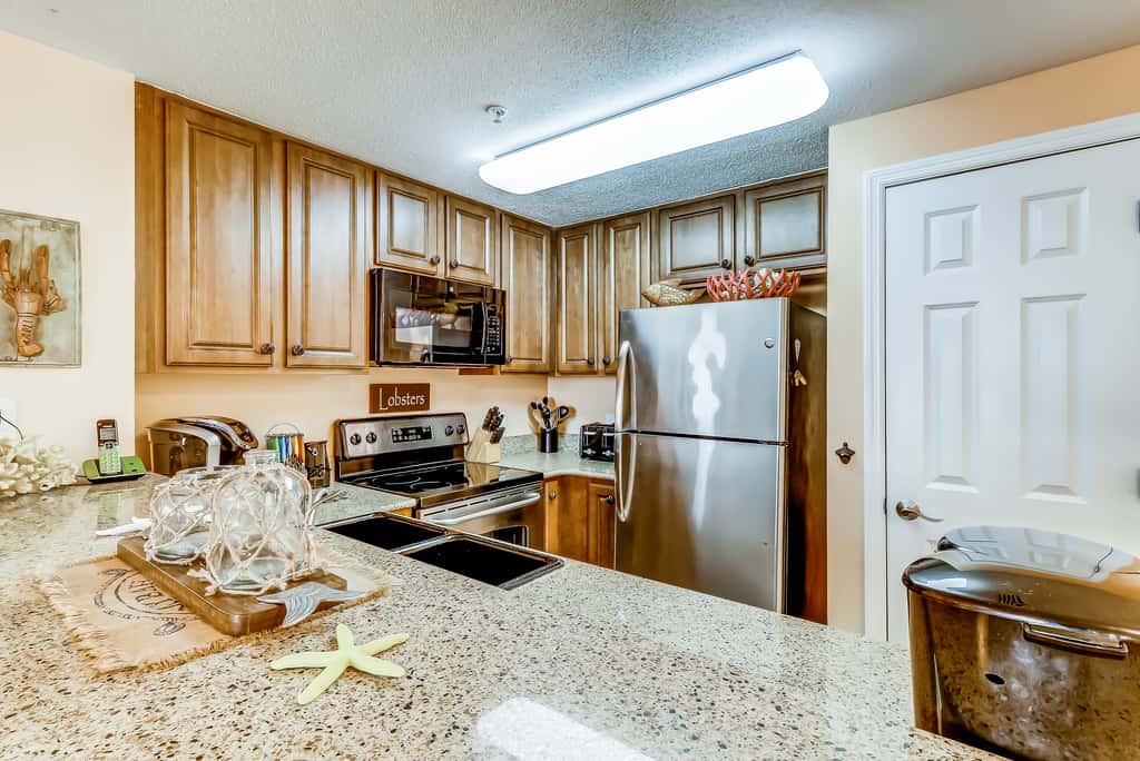 Serene & upscale beachfront condo with furnished balcony, view, & pools