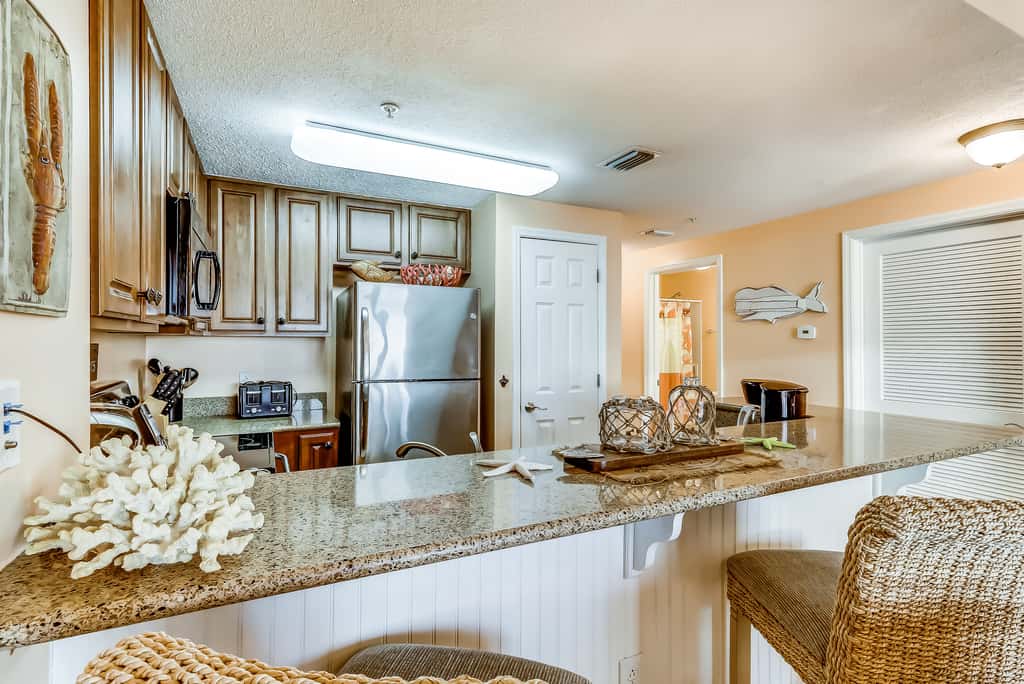 Serene & upscale beachfront condo with furnished balcony, view, & pools