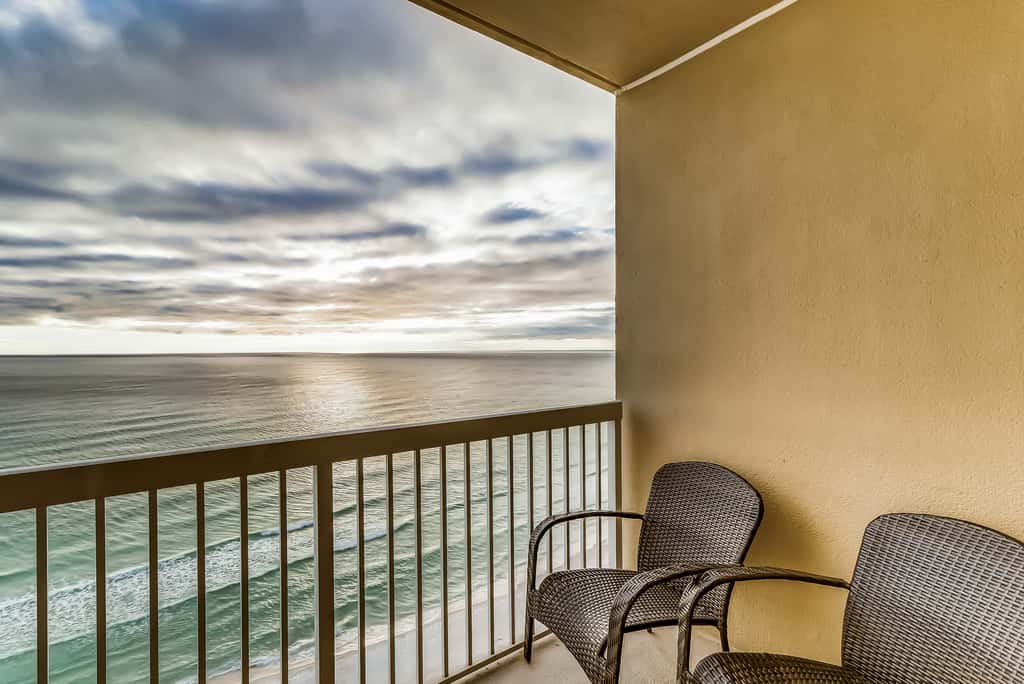 Serene & upscale beachfront condo with furnished balcony, view, & pools