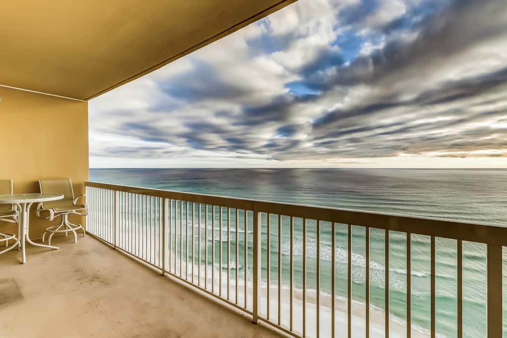 Serene & upscale beachfront condo with furnished balcony, view, & pools