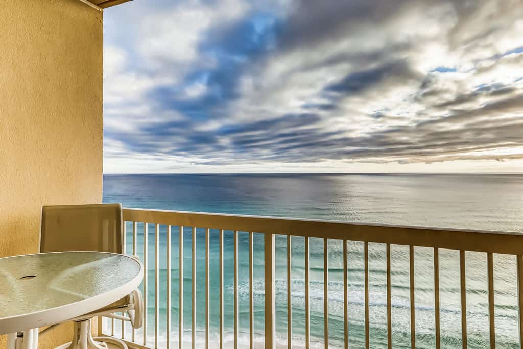 Serene & upscale beachfront condo with furnished balcony, view, & pools
