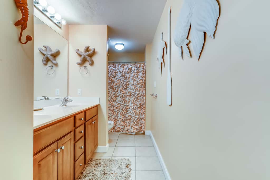 Serene & upscale beachfront condo with furnished balcony, view, & pools