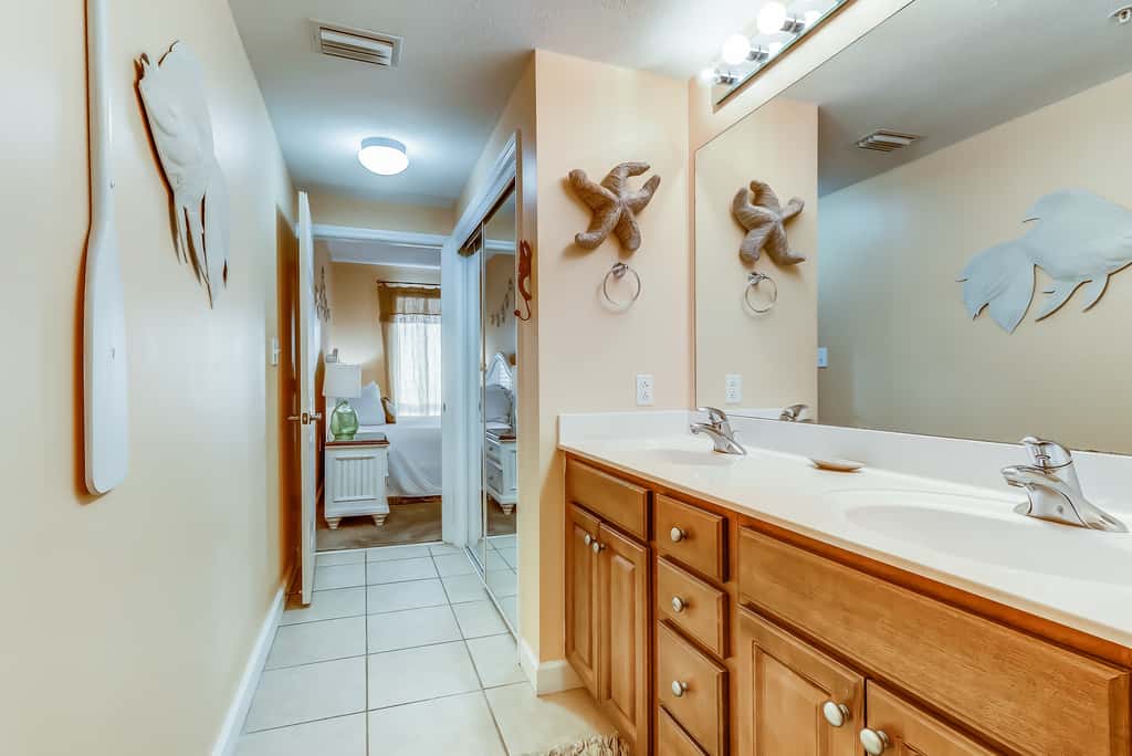 Serene & upscale beachfront condo with furnished balcony, view, & pools
