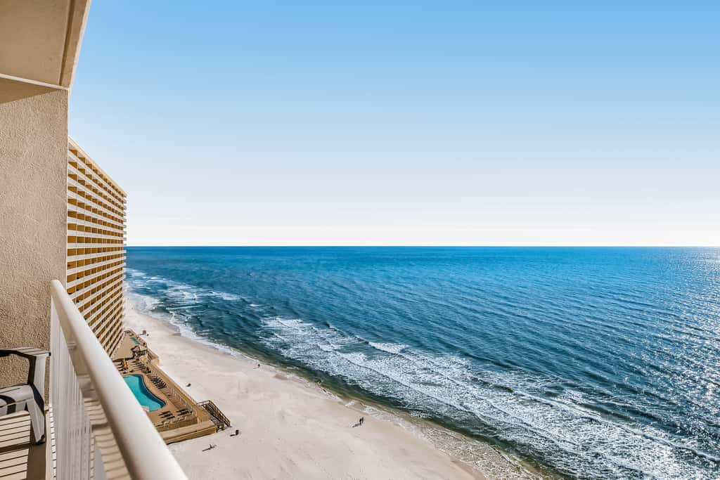 Tropical, waterfront oasis with furnished balcony, pools, & beach access