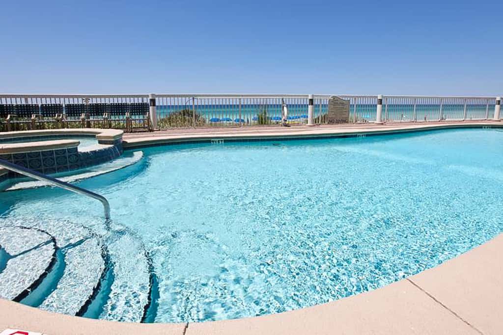 Tropical, waterfront oasis with furnished balcony, pools, & beach access