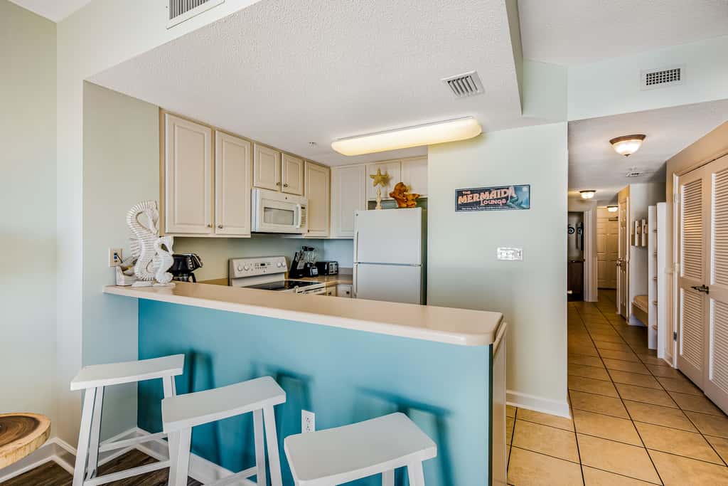 Tropical, waterfront oasis with furnished balcony, pools, & beach access