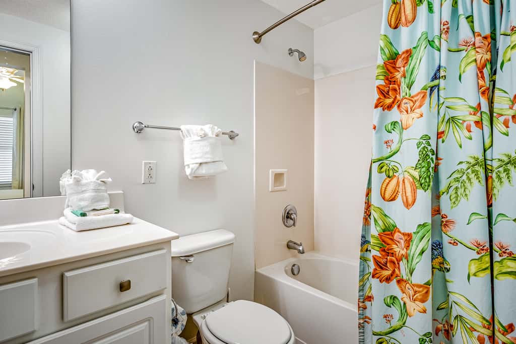 Tropical, waterfront oasis with furnished balcony, pools, & beach access