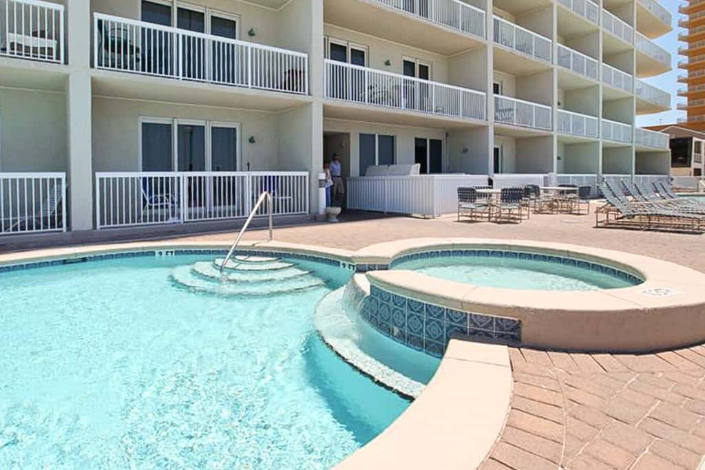 Tropical, waterfront oasis with furnished balcony, pools, & beach access