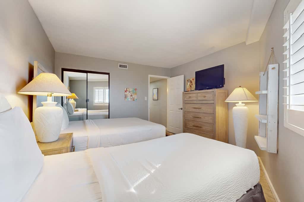8th floor condo with Gulf views, balcony, pools, hot tubs, central AC, and WiFi