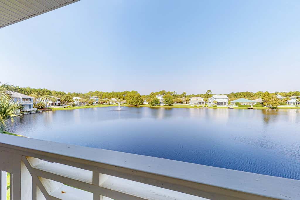 Lakefront condo with water-view balcony, private golf cart, resort pool & amenities