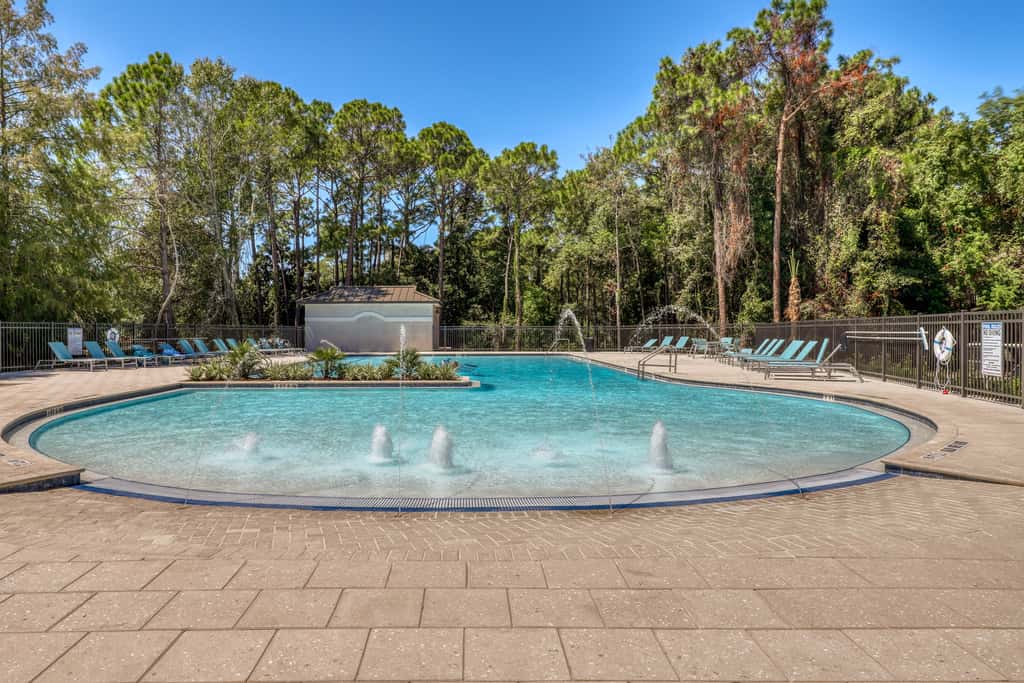 Lakefront condo with water-view balcony, private golf cart, resort pool & amenities