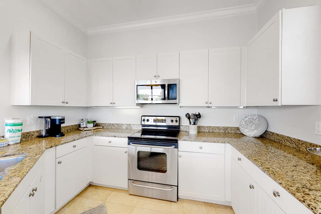 Lakefront condo with water-view balcony, private golf cart, resort pool & amenities