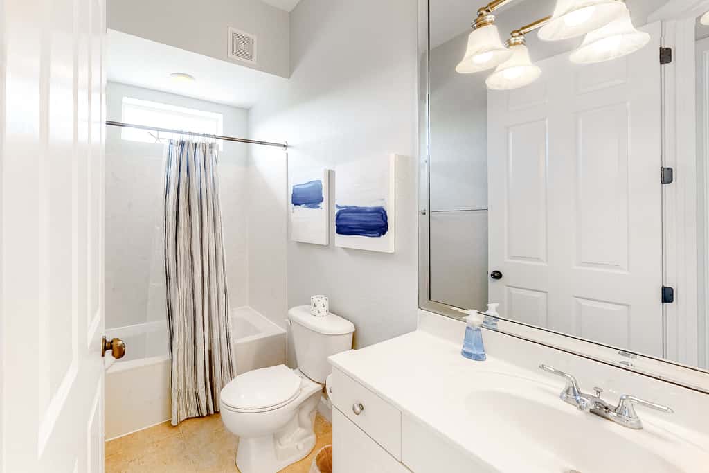 Lakefront condo with water-view balcony, private golf cart, resort pool & amenities