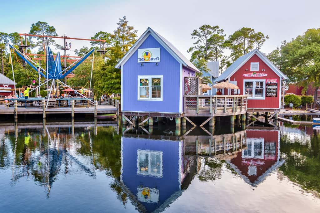 Lakefront condo with water-view balcony, private golf cart, resort pool & amenities