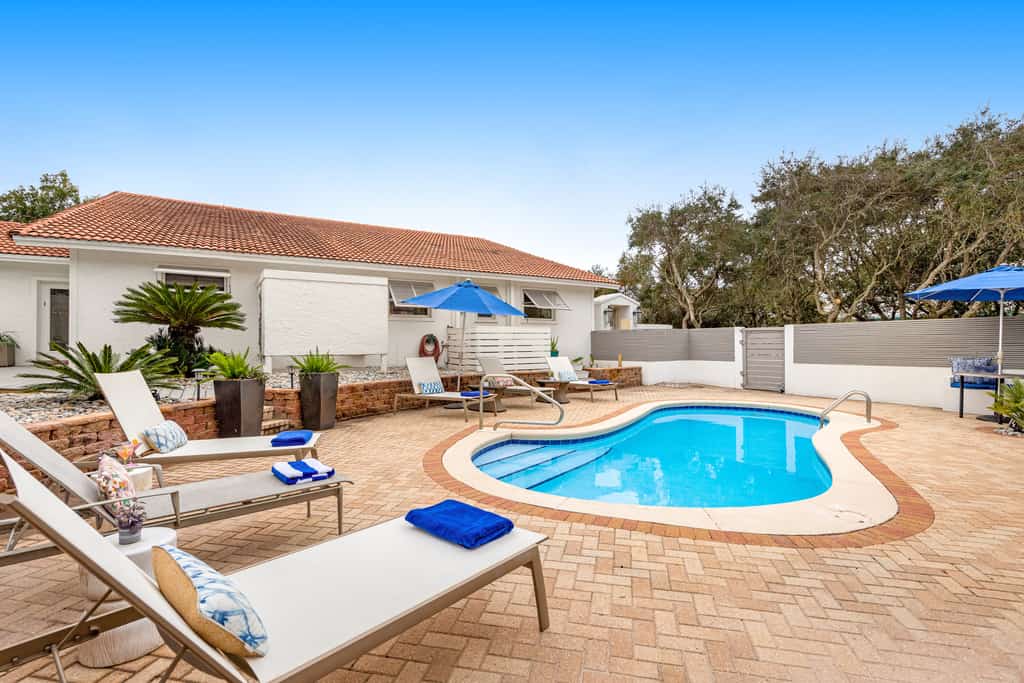Enchanting ocean-view home with pool, bikes, balcony & private beach access