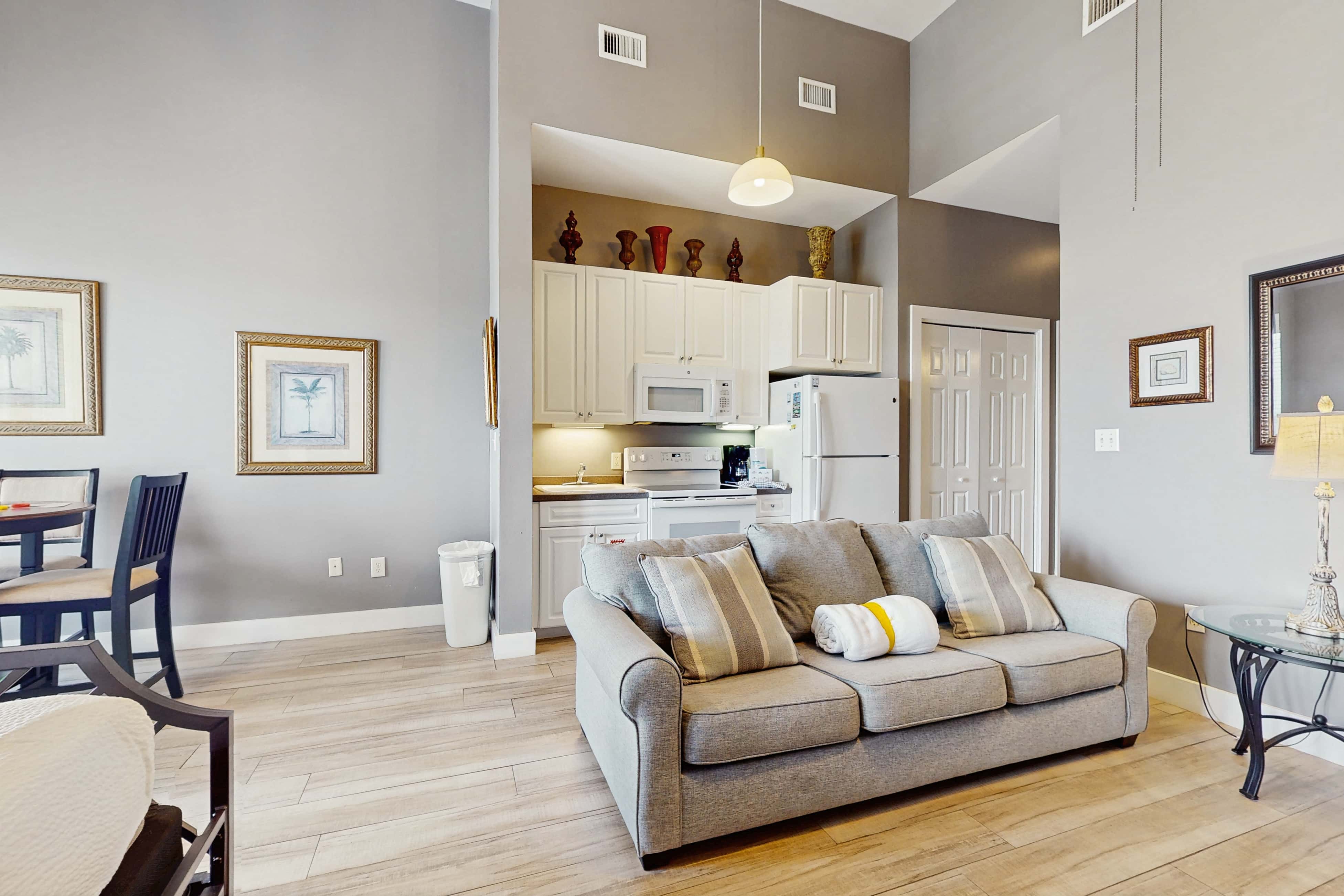 Spacious condo with large living area, private balcony & shared pool