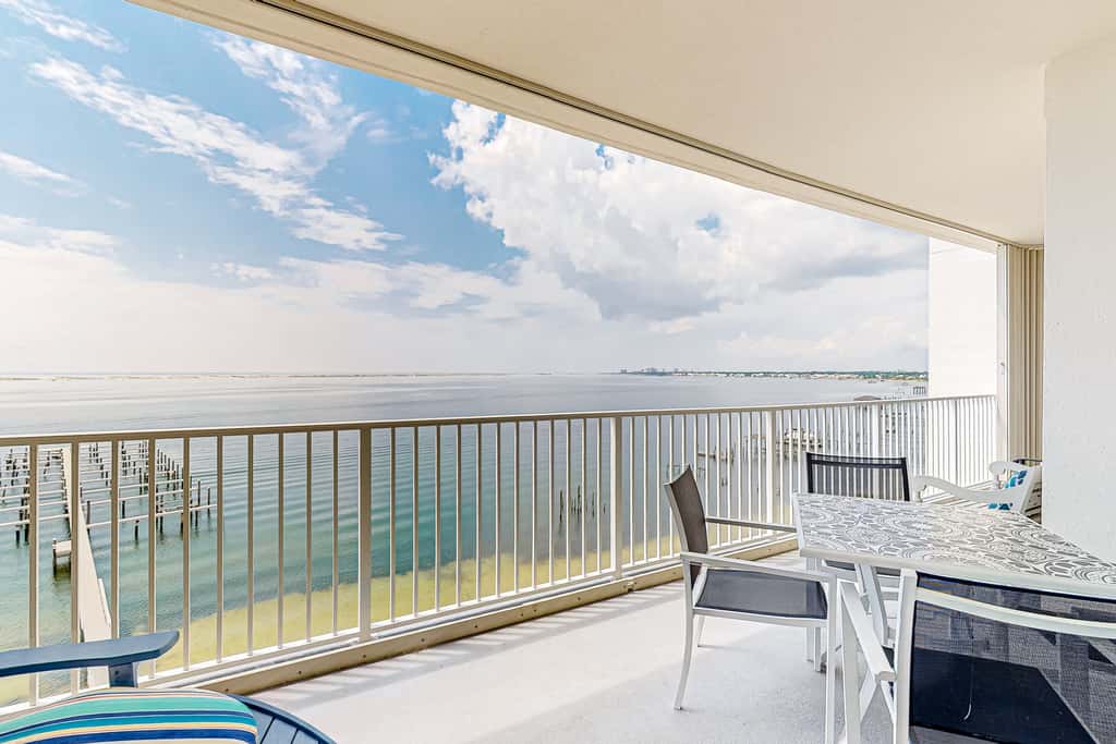 Waterfront condo with beach access, pools, balcony, central AC, & W&D