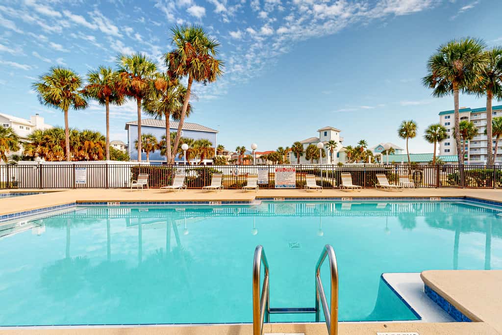 Sunny condo with pool, hot tub, pool views, balcony, & AC