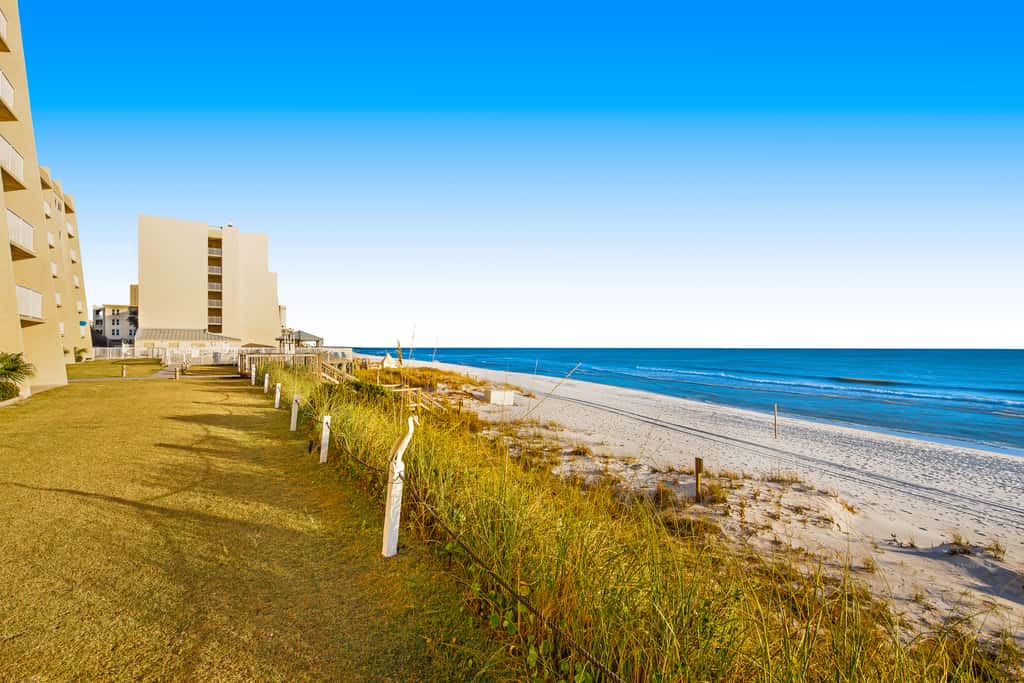 Gulf and beachfront condo with furnished patio, outdoor pool, gym & tennis