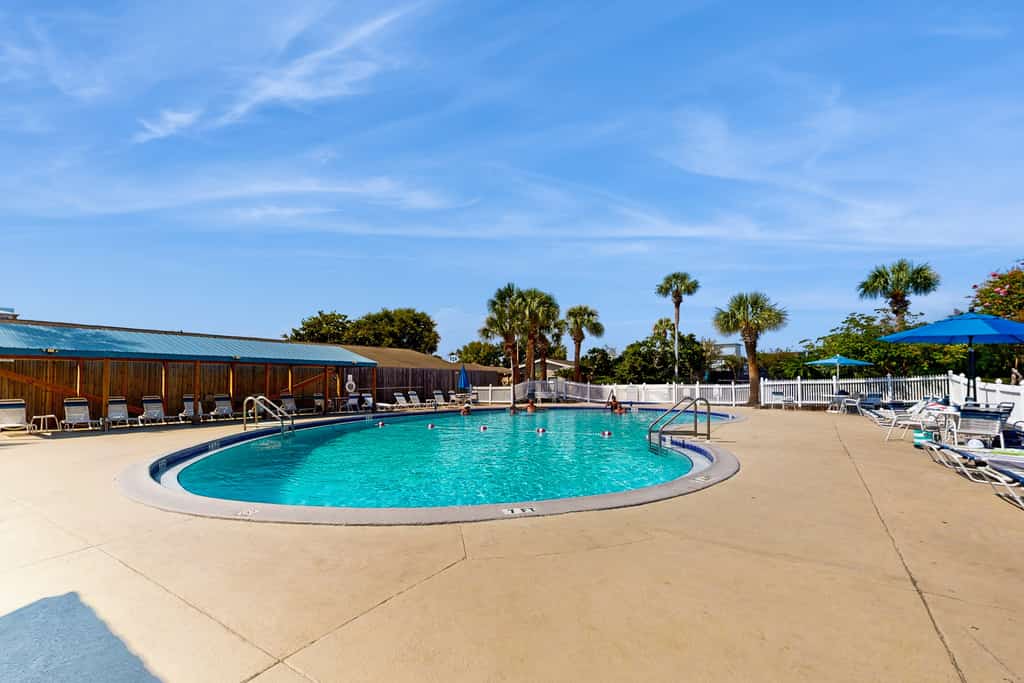 Cozy coastal ground floor condo with patio, shared pool & beach access